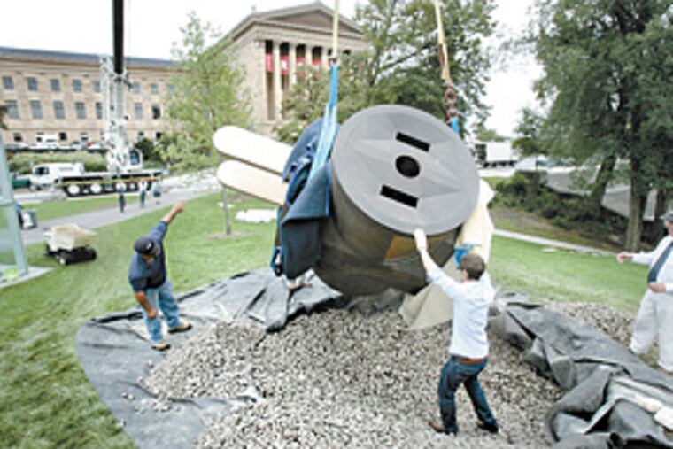 Claes Oldenburg's "Giant Three-Way Plug, Scale A" is put in place. It was donated by philanthropist David Pincus to honor the museum's late director, Anne d'Harnoncourt. (David Swanson / Staff Photographer)