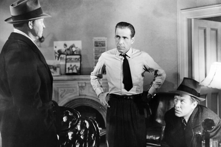 Humphrey Bogart as Sam Spade faces off with police detectives played by Barton MacLane (left) and Ward Bond in "The Maltese Falcon." John Huston's classic 1941 movie of Dashiell Hammett's 1929 novel is screening in 650 theaters nationwide. Warner Bros.