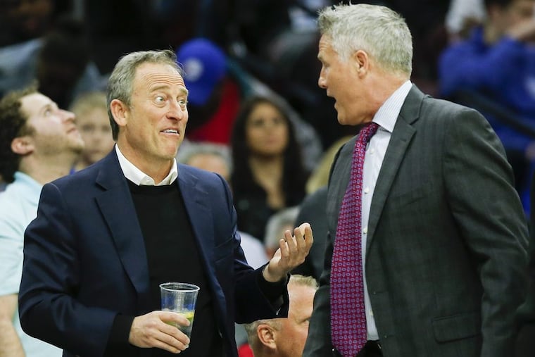 Sixers Owner Josh Harris talks to Sixers Head Coach Brett Brown during the second-quarter against the Milwaukee Bucks on Wednesday, April 11, 2018 in Philadelphia. YONG KIM / Staff Photographer