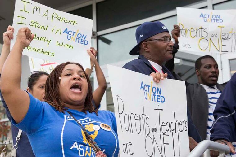 Dawn Hawkins, front left, from United Action, protests. Philadelphia public school parents and local advocacy groups protest the SRC's recent move to cancel the contract for teachers, nurses and staff, October 15th, 2014, on the front steps of the school district building, located at 440 N. Broad Street, Philadelphia, PA. Staff Photographer / Jessica Griffin