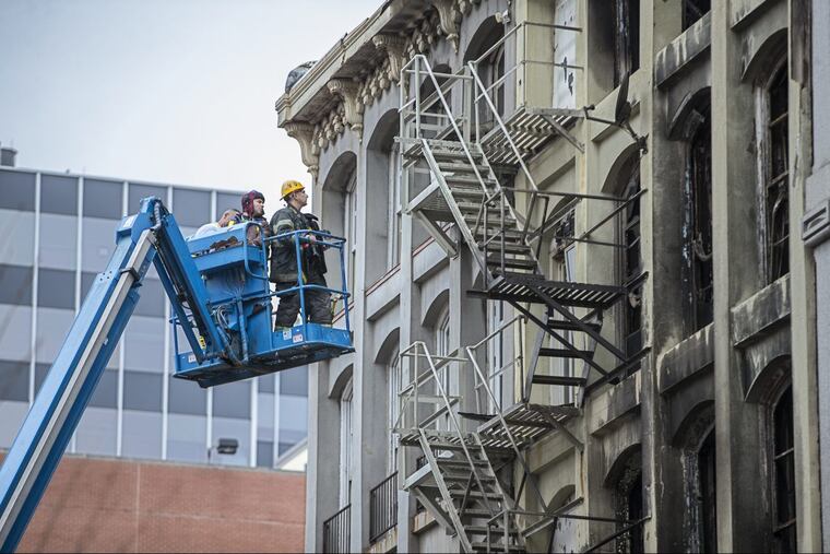 A Philadelphia Fire Department photographer documents the devastation of the Chestnut Street blaze that caused about 150 people to be evacuated on Sunday.