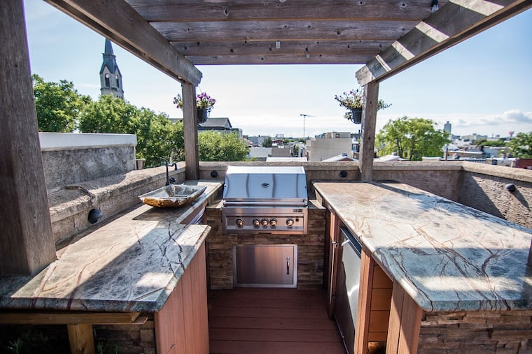 The roof deck of the townhouse has city views and an outdoor kitchen.
