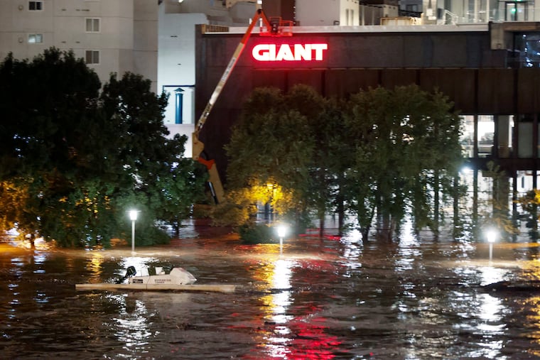 A Vesper Boat Club boat floats unmanned down the raging Schuylkill River in Center City Phila. Pa. just before 3:30 am on Sept. 2, 2021. Rain from Hurricane Ida caused major flooding around the Phila. area. The new Giant food store seen in the background flooded. Pennsylvania's Climate Action Plan for 2021 says to state's residents should expect more extreme events.