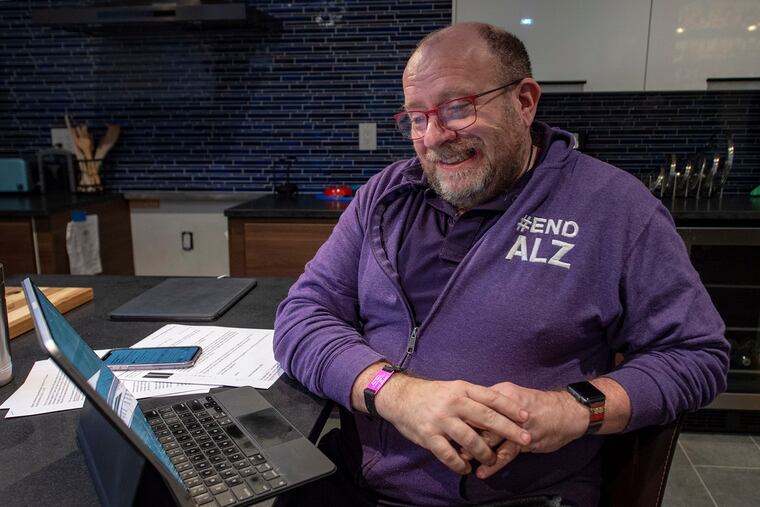 Phil Gutis reads over his work at home in New Hope in November. He was diagnosed with Alzheimer’s five years ago and is taking part in an experimental trial.