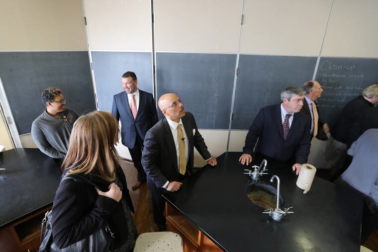Sen. Vince Hughes ( Center ) and other dignitaries enter Overbrook High School on Monday, Nov. 21.