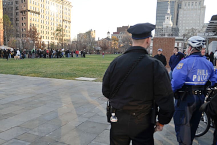 Police keeping a distance from protesters Saturday. While some call last week’s detentions illegal, the department defended its actions. (Ron Tarver / Staff Photographer)