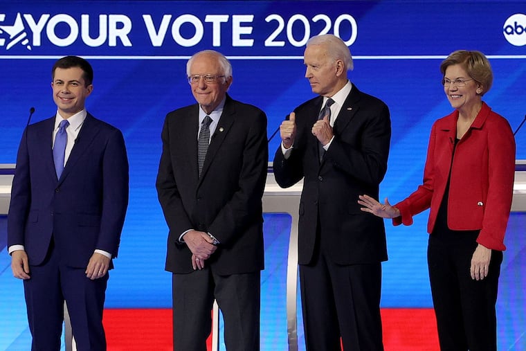 From left, Democratic presidential candidates Pete Buttigieg, Bernie Sanders, Elizabeth Warren, and Joe Biden at a primary debate in the Sullivan Arena at St. Anselm College in Manchester, N.H., on Feb. 7.
