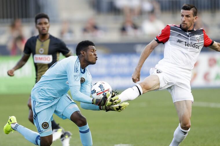Union goalkeeper Andre Blake makes a save against D.C. United forward Sebastien Le Toux. YONG KIM / Staff Photographer