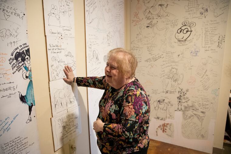Ellen Mager looks at her "wall of fame" inside Booktenders Secret Garden, the oldest children's book store in the Philadelphia region, in Doylestown. Mager is selling the wall that includes the signatures of J.K. Rowling, Marc Brown and many other award-winning authors and publishers in order to keep her financially struggling store afloat.