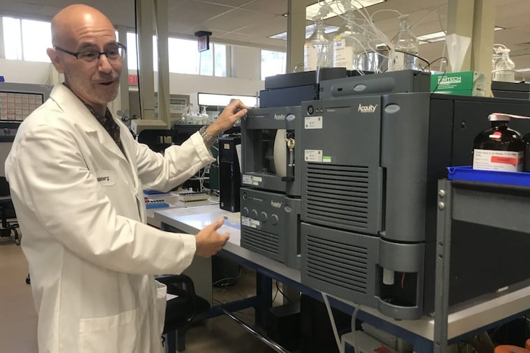 At NMS Labs in Willow Grove, lab director Rob Middleberg examines one of the gas chromatography instruments.