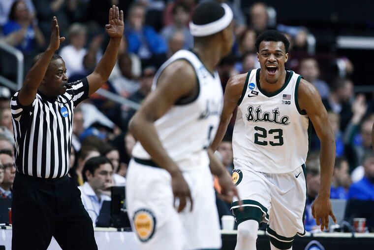 Michigan State forward Xavier Tillman (23) reacts to scoring against LSU during the first half of an East Regional semifinal in the NCAA men's college basketball tournament in Washington, Friday, March 29, 2019. (AP Photo/Patrick Semansky)