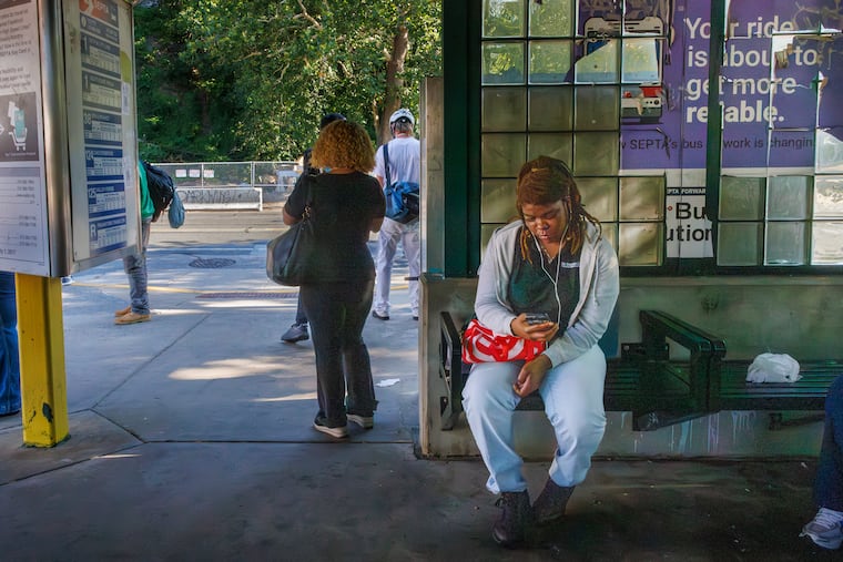 At top right is a sign that was vandalized that reads, “Your ride is about to get more reliable” at the SEPTA Wissahickon Transportation Center on Ridge Avenue Monday morning.