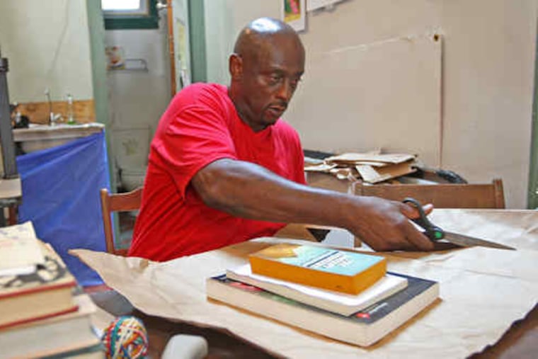 James Bixon, a Books Through Bars volunteer and an ex-conwho benefited from the program, prepares a package.