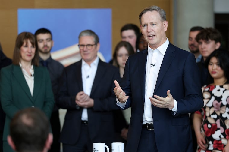 Comcast Corp. executive Michael Cavanagh, gesturing, with British Prime Minister Keir Starmer (center) and Chancellor of the Exchequer Rachel Reeves (left), announcing in April 2025 that Comcast will build its first Universal theme park and resort in Europe north of London to open in 2031.