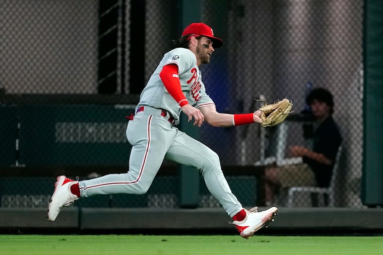 Phillies right fielder Bryce Harper makes a running catch to retire Atlanta's Travis d'Arnaud in the second inning.