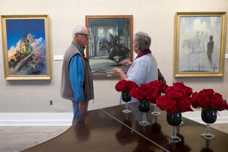 An exhibit of rarely seen paintings by N.C. Wyeth are now on display at the Chester County Art Association for a brief and limited time. Here, Robert Sprague and his wife Russ, of Paoli, view the paintings, including "The Old
Continentals", "Paul Revere's Ride" and "The Unknown Soldier". (ED HILLE / Staff Photographer)