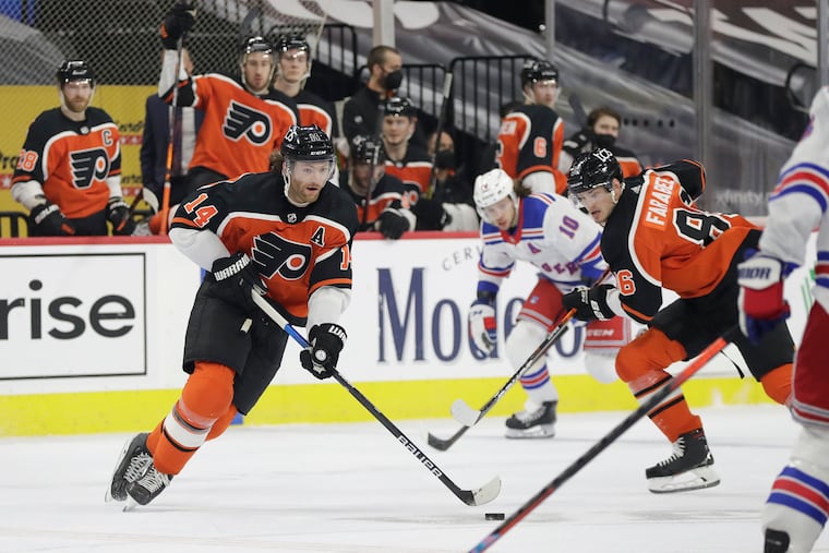 Flyers center Sean Couturier (left) skates with the puck in Saturday's 2-1 win over the Rangers. Couturier has 24 points in 22 games this season.