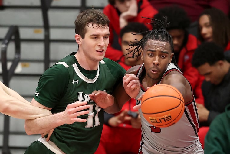 Cameron Brown (right) of St. Joseph's strips the ball away from Milos Ilic of Loyola of Maryland in December.