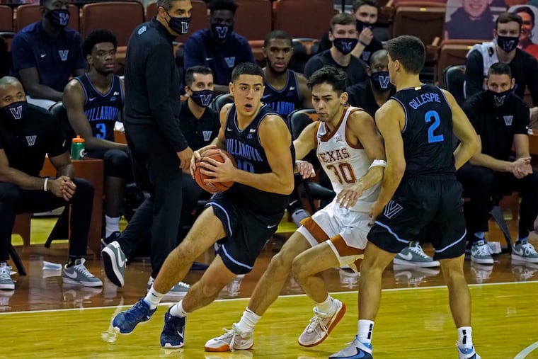 Villanova forward Cole Swider drives around a screen set by teammate Collin Gillespie against Texas forward Brock Cunningham .