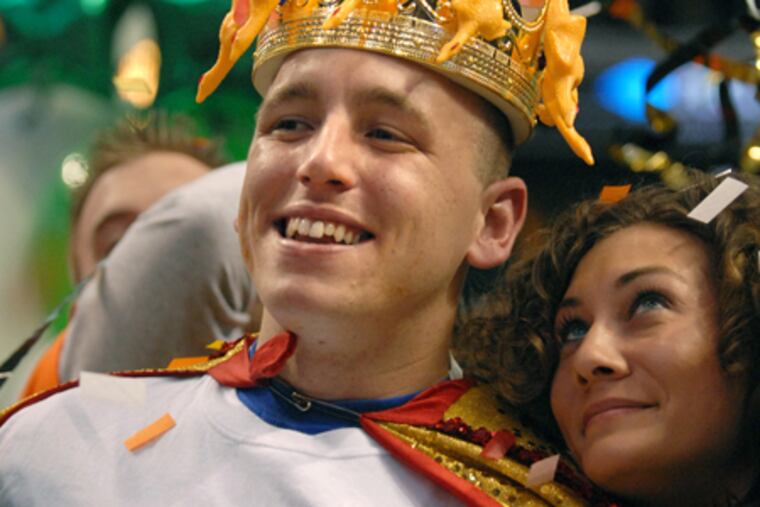 Joey Chestnut celebrates his win at last year's Wing Bowl with a supporter. The odds-on favorite to retain his crown, he will be challenged by five-time champion Bill "El Wingador" Simmons.