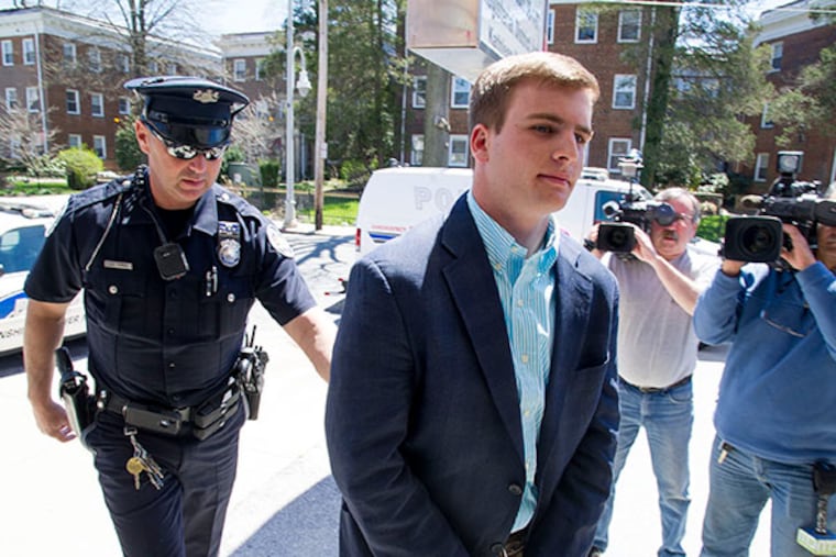 Timothy C. Brooks is led into Montgomery County Magisterial District Court in handcuffs after being arrested as one of the alleged leaders of a drug distribution ring that sold to local high schools and colleges on April 21, 2014. ( CLEM MURRAY / Staff Photographer )