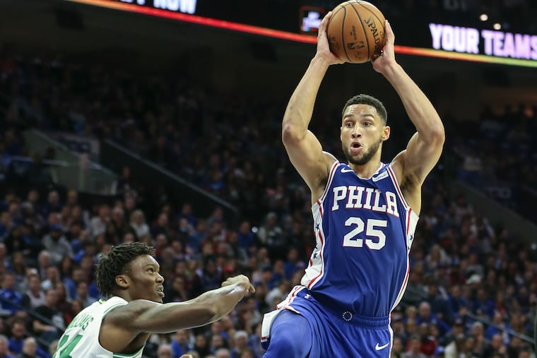 Sixers point guard Ben Simmons looks to pass over the Celtics' Robert Williams during the season opener.
