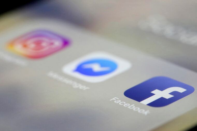 FILE- In this March 13, 2019, file photo Facebook, Messenger and Instagram apps are are displayed on an iPhone in New York. Facebook, Instagram and WhatsApp were temporarily down early Sunday, April 14. All three social media platforms, including Facebook Messenger, were affected by the outage. (AP Photo/Jenny Kane, File)