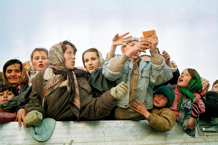I went to an aid distribution site, where I had to wade through the crowd of desperate people — mostly adults — and plead with the humanitarian worker who handed me a loaf a bread. I can’t forget that bread, not even 33 years later, writes Emina Ćerimović. In this March 1993 photo taken during the Bosnian war, refugees evacuated from the besieged Muslim enclave of Srebrenica jostle for a piece of bread on their arrival in Tuzla, Bosnia.