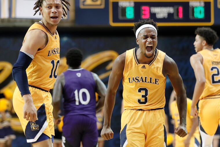 La Salle's Josh Nickelberry (left) looks on as Explorers teammate Anwar Gill (center) lets out a yell during the game.