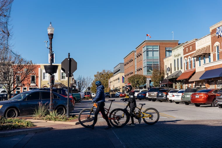 Pedestrians with bicycles at the main downtown square in Bentonville, Ark. MUST CREDIT: Terra Fondriest/Bloomberg