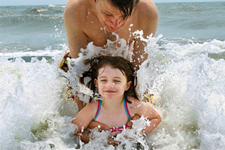 Four-year-old Sophia Dickenson and her father, Rob, play in the surf at Cape May.