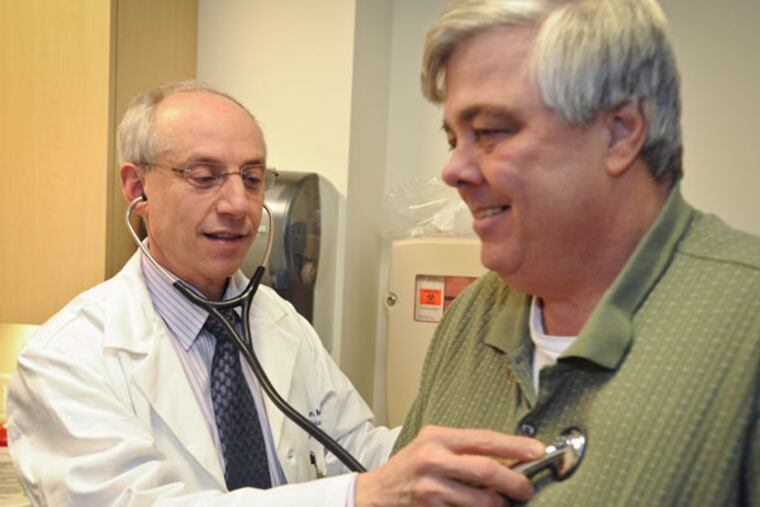 Dr. Howard Herrmann checks his patient Joseph Wills who has had several heart procedures. ( RON TARVER / Staff Photographer )
