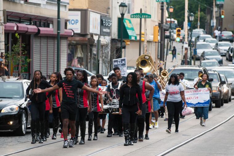Members of the Finest Drill Team and Drum Corps walk down Germantown Avenue for the Juneteenth Parade in Philadelphia on Saturday, June 20, 2015. (MICHAEL PRONZATO/Staff Photographer)