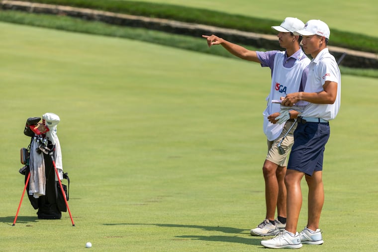 Dawson Lew, of Canada, chatting with his caddie, Austin McConnell, at U.S. Amateur Championship on Wednesday.