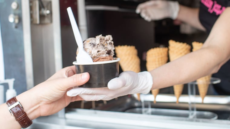 Milk Jawn co-owner Amy Wilson serves a customer. Phila and Rachel Lorn's 4-year-old son is a big fan of the ice cream shop.
