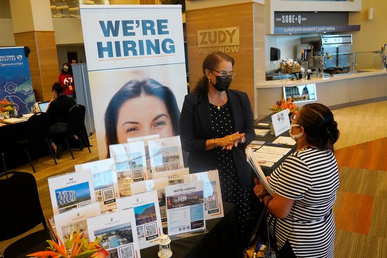 Marriott human resources recruiter Mariela Cuevas, left, talks to Lisbet Oliveros, during a job fair at Hard Rock Stadium, Friday, Sept. 3, 2021, in Miami Gardens, Fla.
