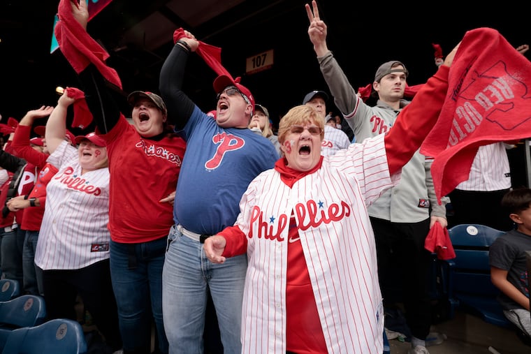 Phillies fans (from left) Lorraine Faix, her son Kevin Faix, his girlfriend Tiffany Harris, and Lisa Faix cheer Rhys Hoskins' two run home run in the third inning of Game 5 of the NLCS.