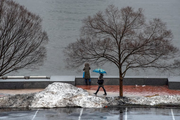 Leftover snow piles at the end of last winter linger at Penn's Landing. The first flakes of the 2021-22 season landed in the region on Tuesday.