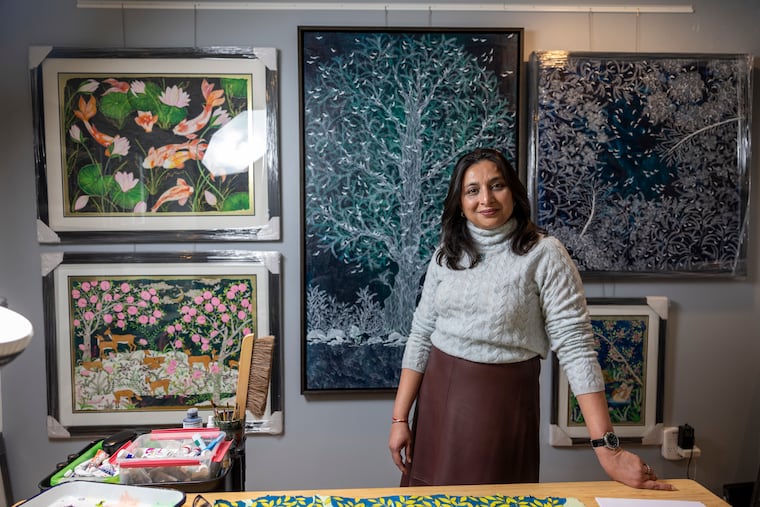 Rinal Parikh, 43, Media-based artist, poses for a portrait in her studio with a few of her paintings framed on the wall in her home on Tuesday, Dec. 23, 2025.