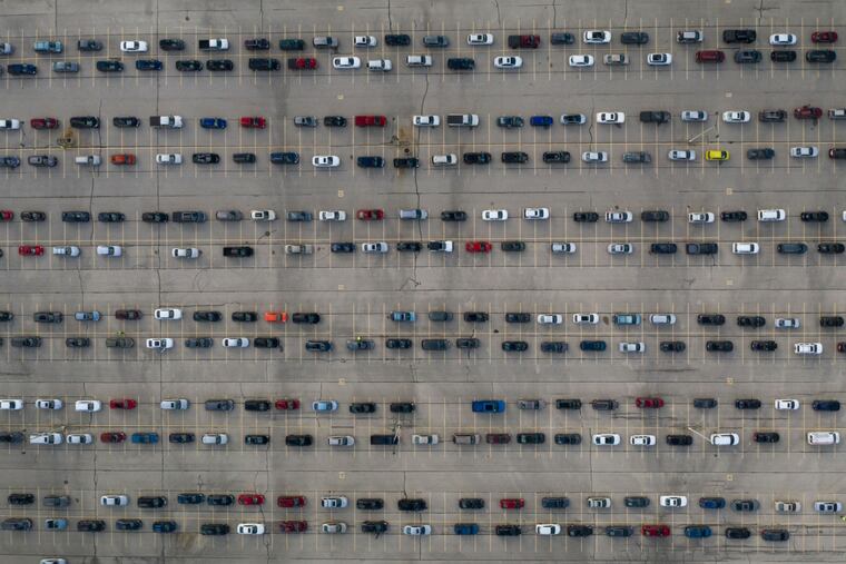 People in vehicles waited in line for drive-through coronavirus testing in Milwaukee on Monday