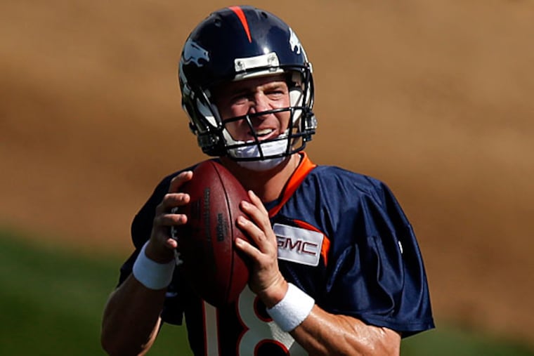 Peyton Manning runs a drill during the first day of NFL football training camp on Thursday, July 24, 2014, in Englewood, Colo. (Jack Dempsey/AP)