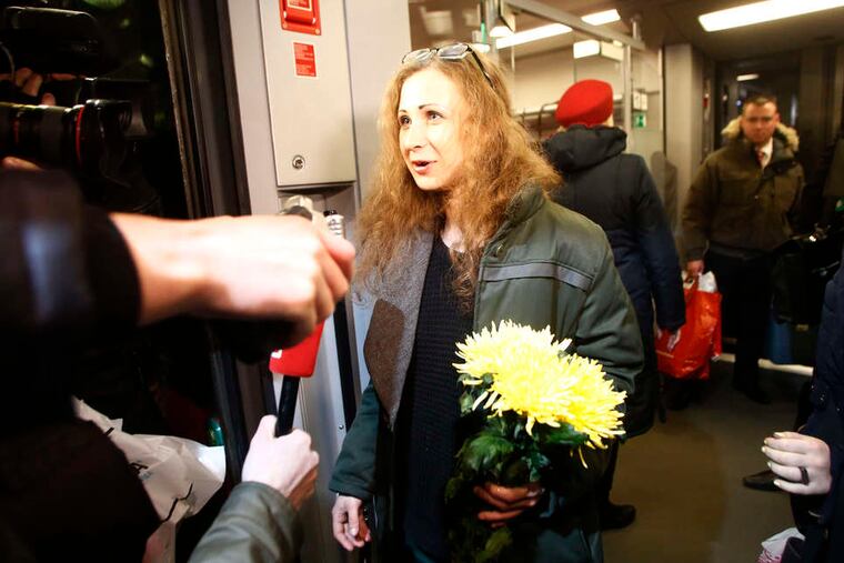 Maria Alekhina , a member of an activist punk band, leaves a train upon her arrival in Moscow. She was freed Monday in a surprising move by Russian President Vladimir Putin. DENIS TYRIN / Associated Press