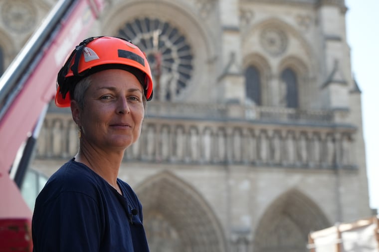 Camille Colonna, archaeologist in charge of operations, wears a safety helmet in front of Notre Dame Cathedral during excavations in Paris, Monday, June 1, 2026.