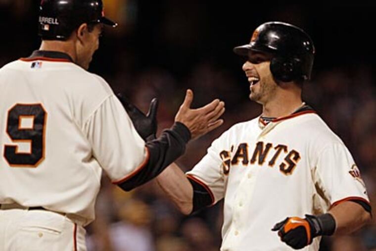Former Phillies Pat Burrell (9) and Aaron Rowand, now with the Giants, will face their former team in the NLCS. (AP Photo/Ben Margot)