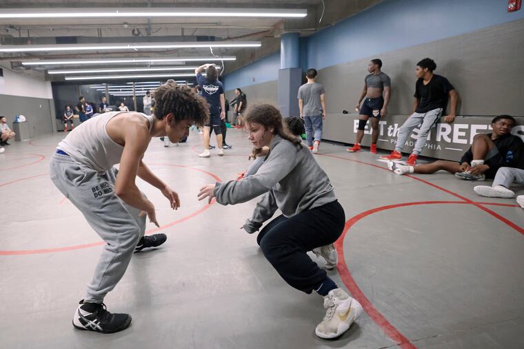 Mariana Bracetti freshman Julissa Ortiz (right) is one of hundreds of high school girls competing in wrestling across Pennsylvania.