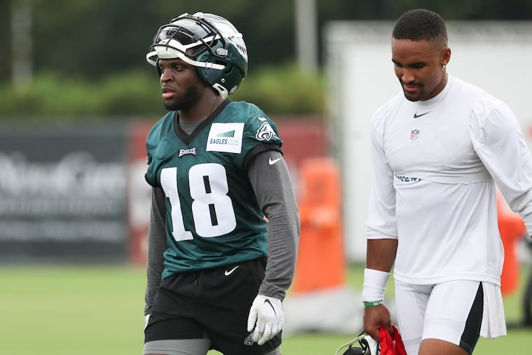 Eagles wide receiver Jalen Reagor and quarterback Jalen Hurts walk off the field together after the second day of training camp at the NovaCare Complex in South Philadelphia on Thursday.