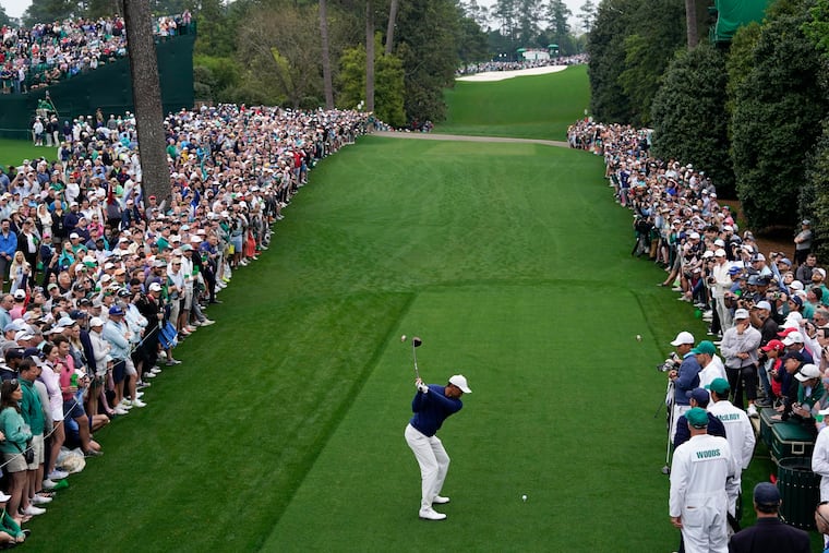 Tiger Woods hits from the 18th tee during a practice for the Masters golf tournament at Augusta National Golf Club.