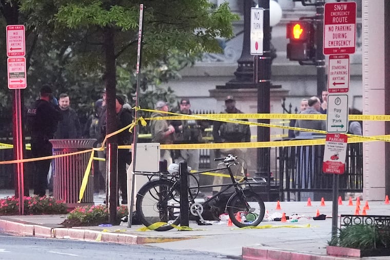 Evidence markers are seen on a crime scene after police responded to reports of shots fired near the White House on Saturday.