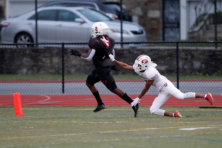 Imhotep Charter's Tykee Smith (2) runs for a TD as Simon Gratz's Tawfiq Smalls defends during the first half of a high school football, Friday Sept. 21, 2018 in Philadelphia Pa. ( H. Rumph Jr / For the Inquirer )