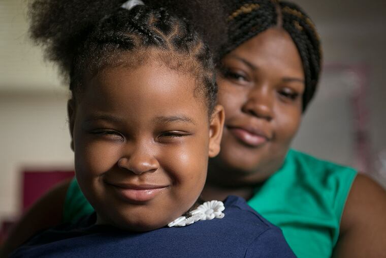 Maziah Mills-Sorrells with mother Essie Mills. Maziah’s left arm was paralyzed during childbirth.